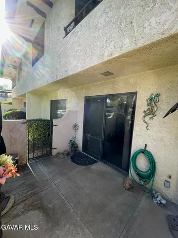 a bathroom with a granite countertop sink a toilet and a mirror