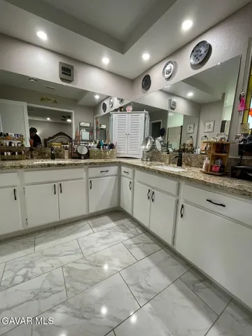 a balcony with table and white walls