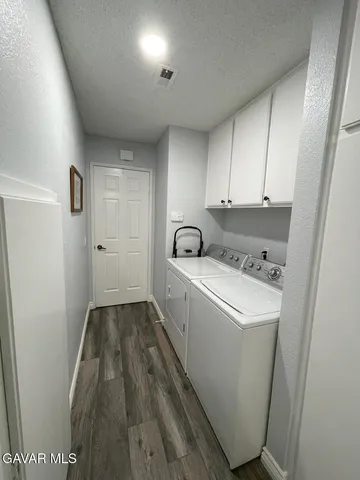 a view of entryway livingroom and hall with wooden floor