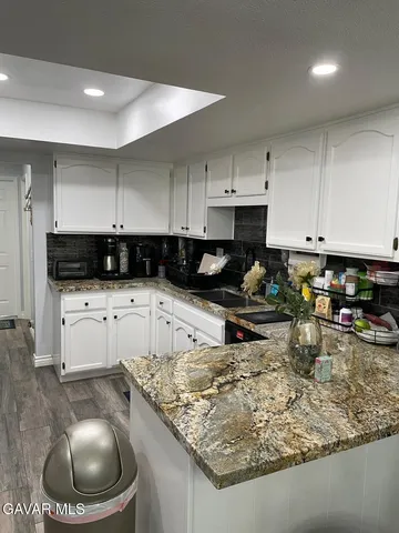 a kitchen with stainless steel appliances and white cabinets