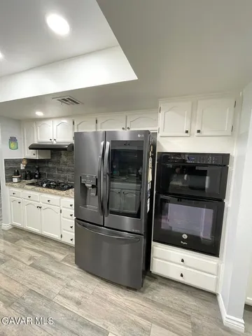 a bathroom with a sink mirror and vanity