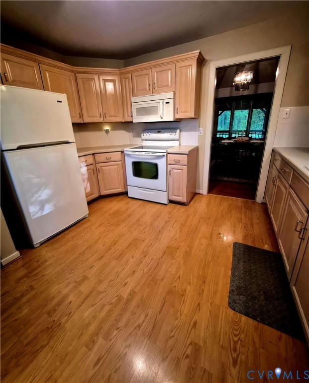 4099 Doe Run Road Hopewell, VA 23860 - Photo 19 of 35 a kitchen with a refrigerator a stove top oven and a dining table