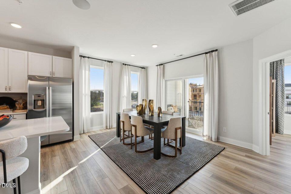 110 Byrum Street, Unit 302 Cary, NC 27511 - Photo 9 of 30 a dining room with furniture and wooden floor
