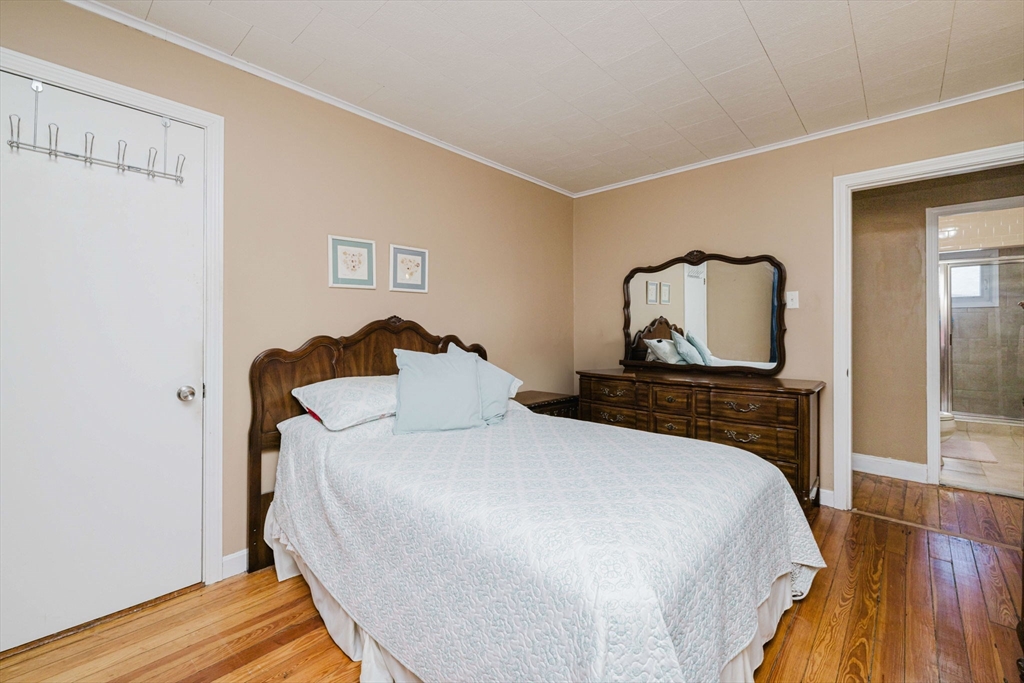 869 Bedford Street Fall River, MA 02723 - Photo 11 of 31 a bedroom with a bed and a mirror on dresser