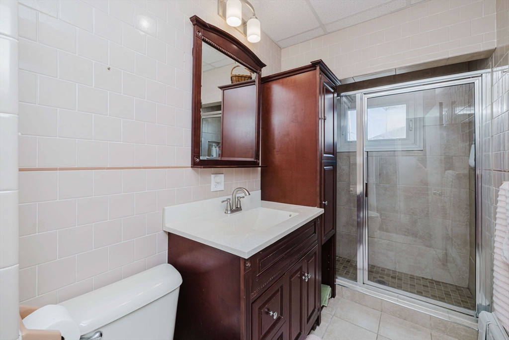 869 Bedford Street Fall River, MA 02723 - Photo 12 of 31 a bathroom with a sink a toilet and shower