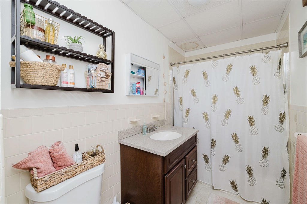 869 Bedford Street Fall River, MA 02723 - Photo 19 of 31 a bathroom with a sink and a mirror