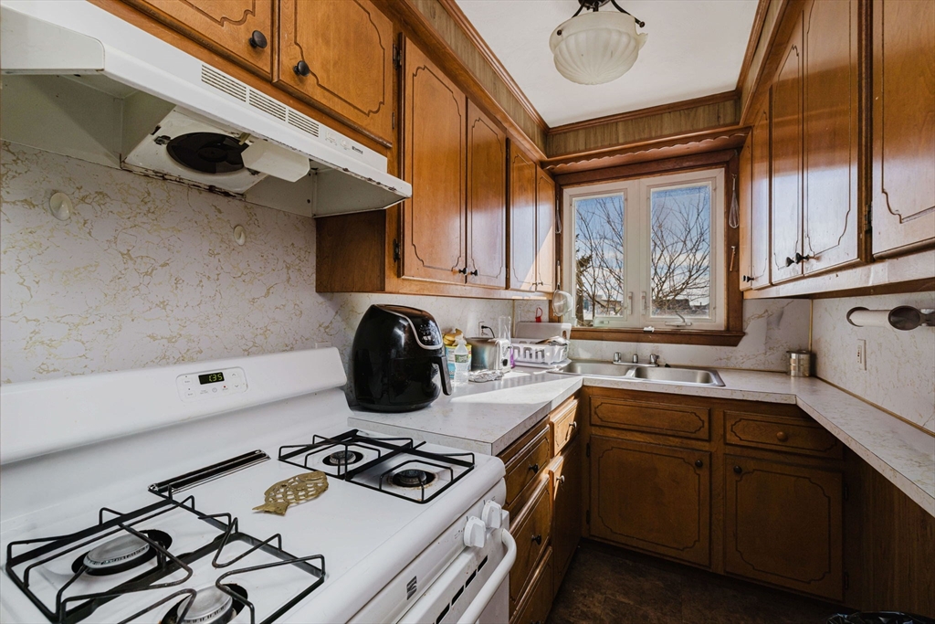 869 Bedford Street Fall River, MA 02723 - Photo 20 of 31 a kitchen with a stove and a sink