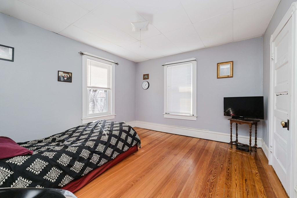 869 Bedford Street Fall River, MA 02723 - Photo 21 of 31 a bedroom with a bed and a flat screen tv
