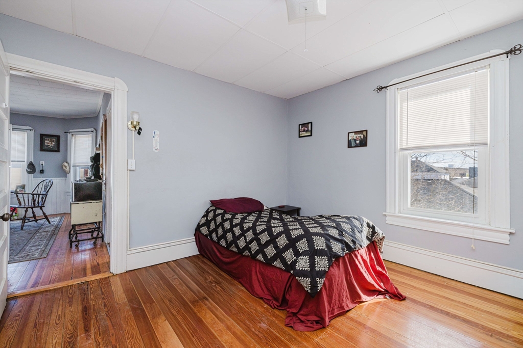 869 Bedford Street Fall River, MA 02723 - Photo 22 of 31 a bedroom with furniture and a wooden floor
