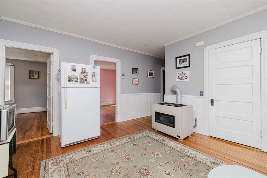 869 Bedford Street Fall River, MA 02723 - Photo 24 of 31 a view of a livingroom with wooden floor and a fireplace