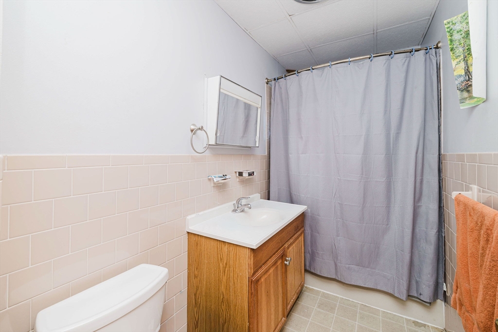 869 Bedford Street Fall River, MA 02723 - Photo 26 of 31 a bathroom with a sink a toilet and a mirror