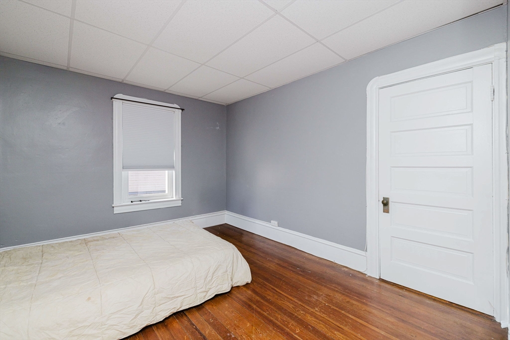 869 Bedford Street Fall River, MA 02723 - Photo 27 of 31 a room with a bed and wooden floor