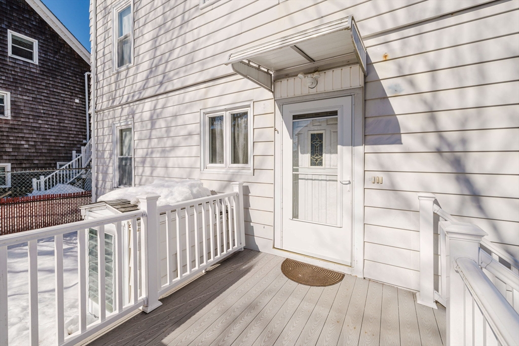 869 Bedford Street Fall River, MA 02723 - Photo 3 of 31 a view of a wooden house with a window
