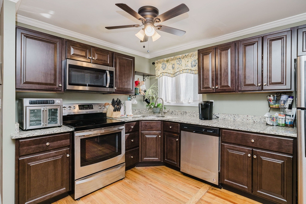 869 Bedford Street Fall River, MA 02723 - Photo 5 of 31 a kitchen with stainless steel appliances granite countertop a stove microwave and sink