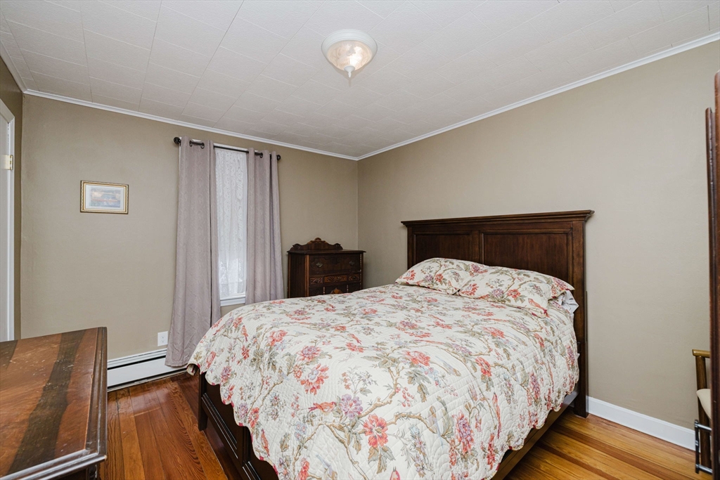 869 Bedford Street Fall River, MA 02723 - Photo 9 of 31 a bedroom with bed and wooden floor