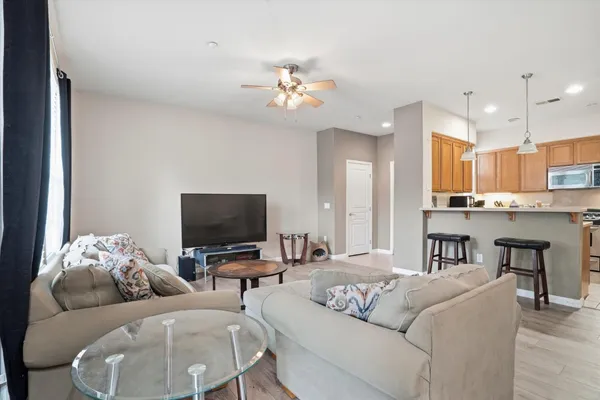 a living room with furniture and a wooden floor