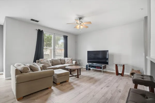 a bathroom with a toilet sink vanity and mirror