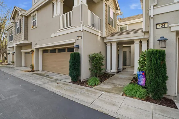 a living room with furniture flat screen tv and a large window