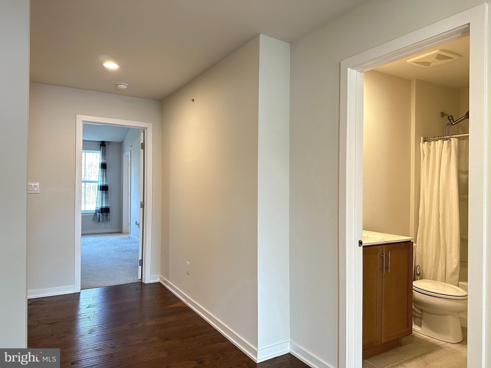 303 Wynstone Court Colmar, PA 18915 - Photo 11 of 26 a view of a hallway with wooden floor and a bathroom