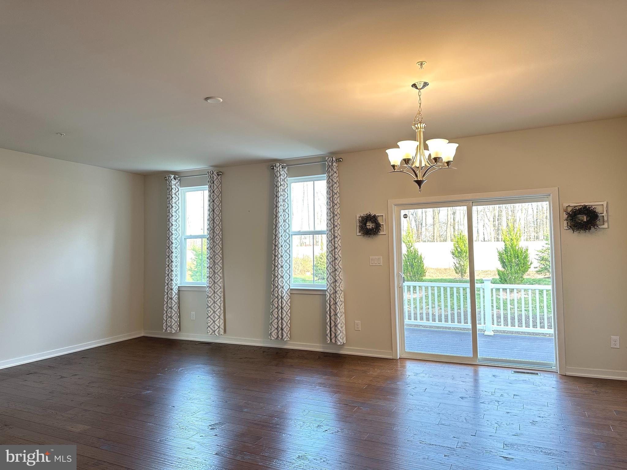 303 Wynstone Court Colmar, PA 18915 - Photo 7 of 26 an empty room with wooden floor and windows
