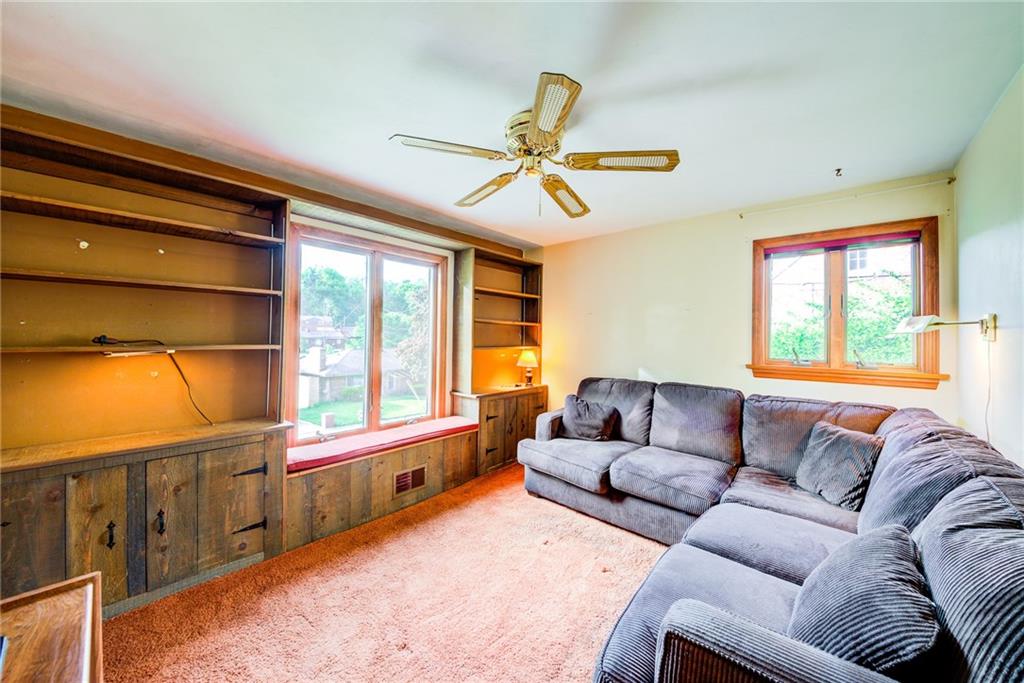 3927 Edge Road Pittsburgh, PA 15227 - Photo 12 of 25 1st floor family room /4th bedroom -- house was built with this room as 4th bedroom -currently being used as the family room w/ built in bookcases and window seat.