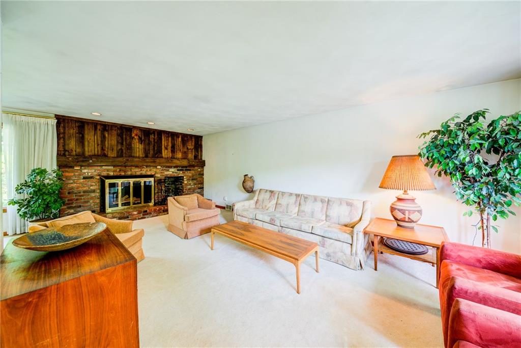 Large living with a handsome brick log burning fire place