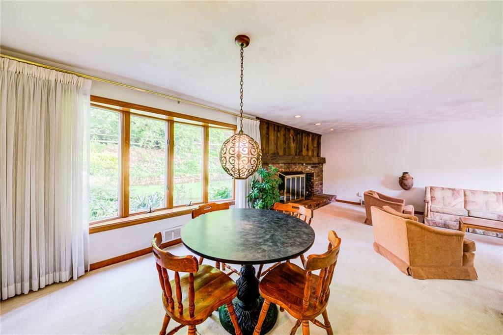 Dining room and living room have large bow windows