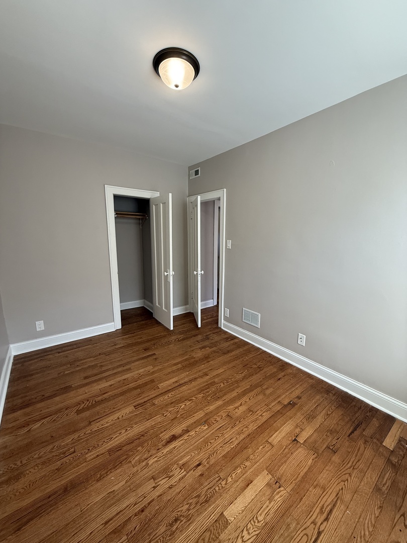 3901 West Division Street, Unit 1150 Chicago, IL 60651 - Photo 6 of 9 wooden floor in an empty room