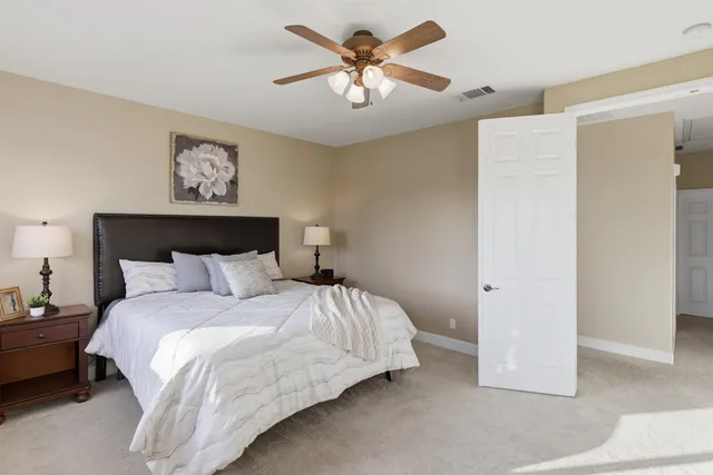 a spacious bathroom with a tub sink and mirror