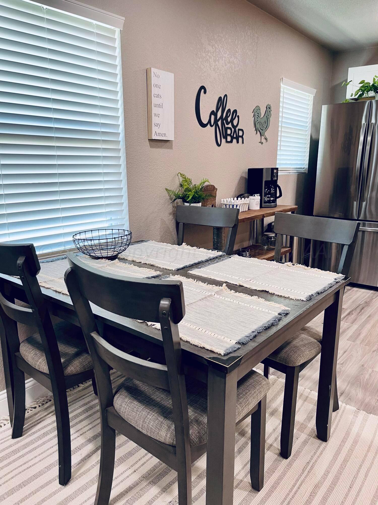 3501 Moss Lane Amarillo, TX 79109 - Photo 19 of 51 a view of a dining room with furniture and wooden floor