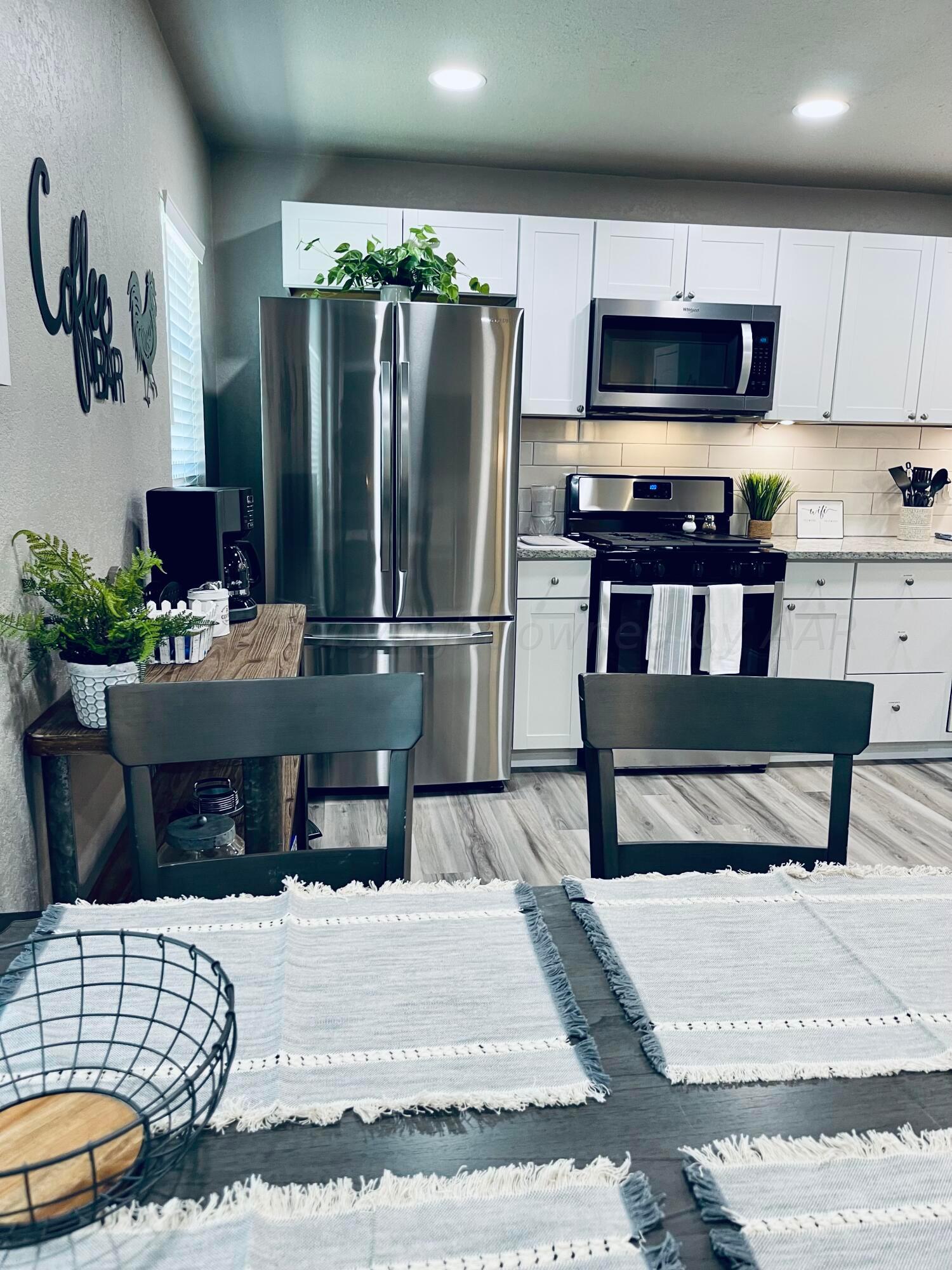 3501 Moss Lane Amarillo, TX 79109 - Photo 20 of 51 a kitchen with kitchen island a stove and a refrigerator
