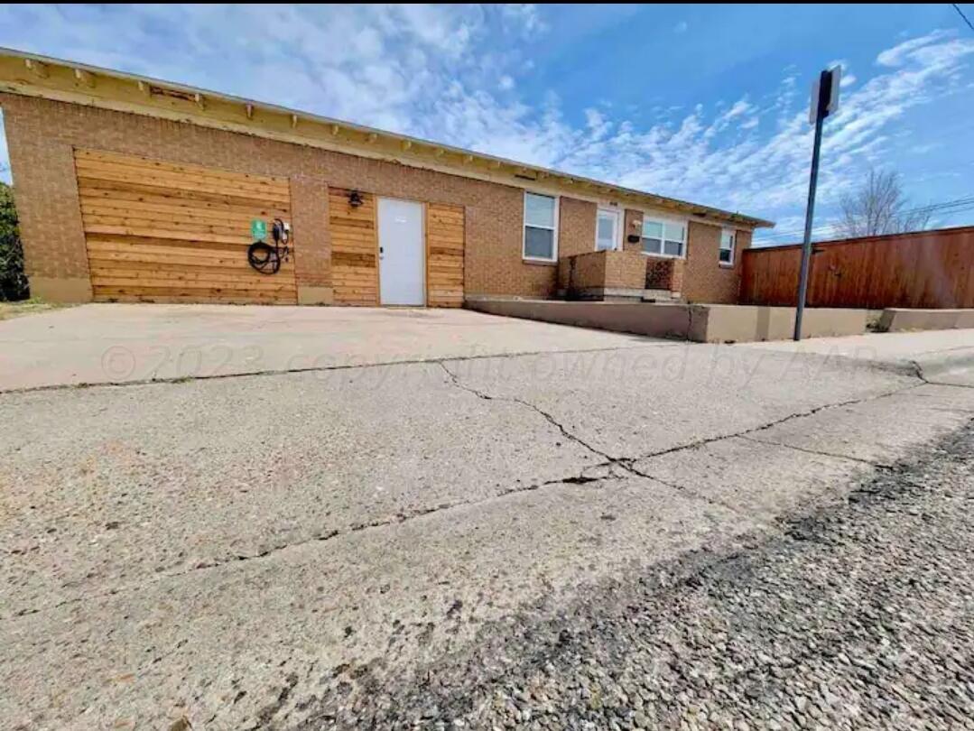 3501 Moss Lane Amarillo, TX 79109 - Photo 41 of 51 a front view of a house with a yard and garage