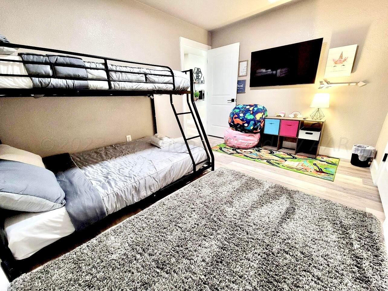 3501 Moss Lane Amarillo, TX 79109 - Photo 43 of 51 a bedroom with bed and flat screen tv