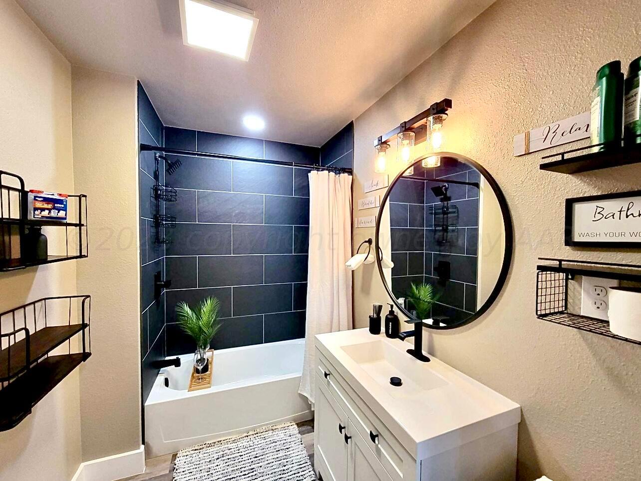 3501 Moss Lane Amarillo, TX 79109 - Photo 45 of 51 a bathroom with a sink and a mirror