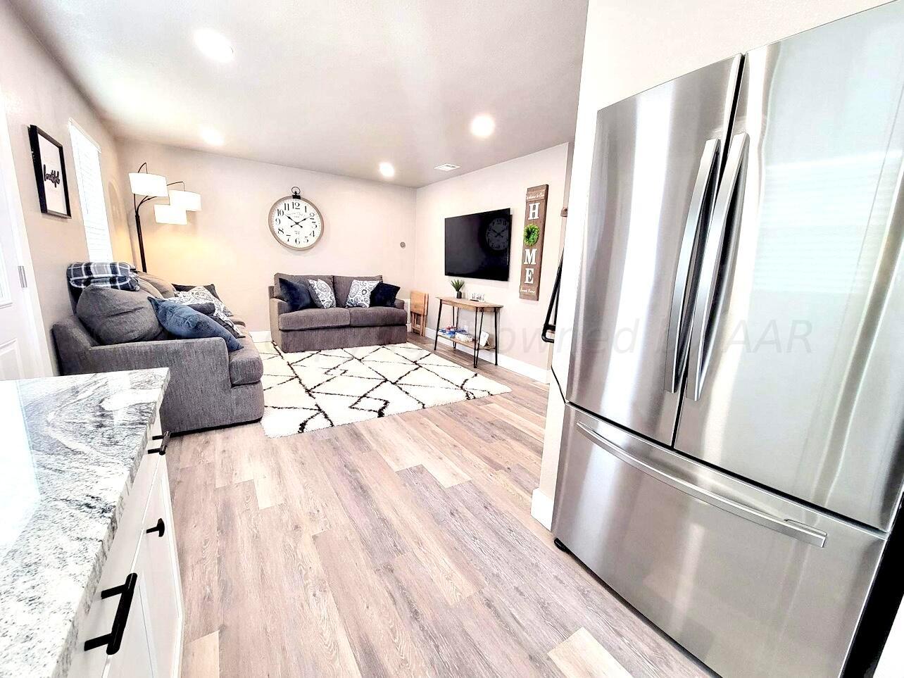 3501 Moss Lane Amarillo, TX 79109 - Photo 49 of 51 a living room with furniture and a flat screen tv