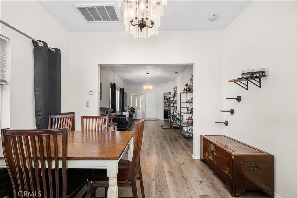 9722 Walnut Street Bellflower, CA 90706 - Photo 13 of 55 a view of a dining room with furniture and wooden floor
