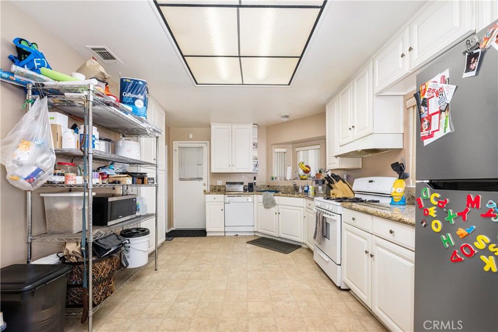 9722 Walnut Street Bellflower, CA 90706 - Photo 15 of 55 a kitchen with cabinets and window