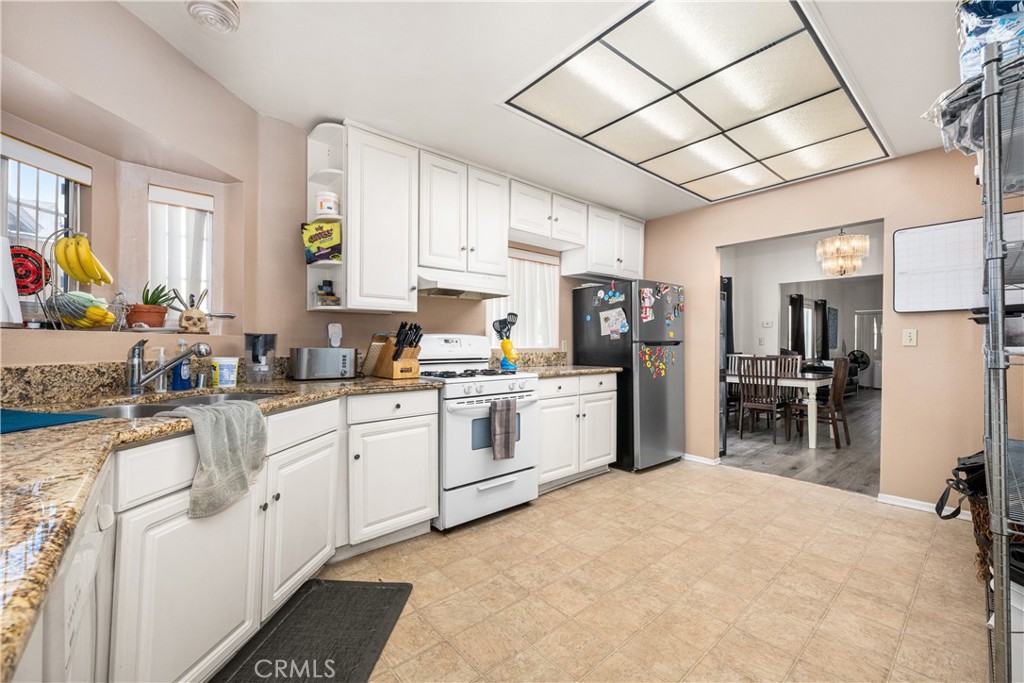 9722 Walnut Street Bellflower, CA 90706 - Photo 17 of 55 a kitchen with appliances cabinets and a sink