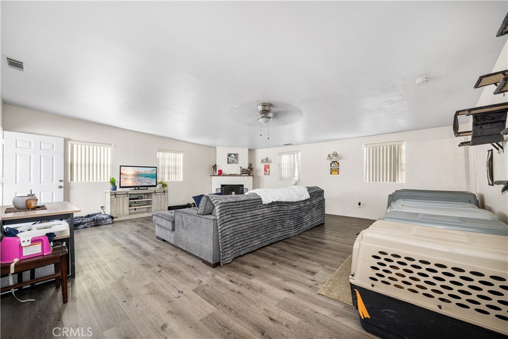 9722 Walnut Street Bellflower, CA 90706 - Photo 20 of 55 a living room with furniture a flat screen tv and a dresser