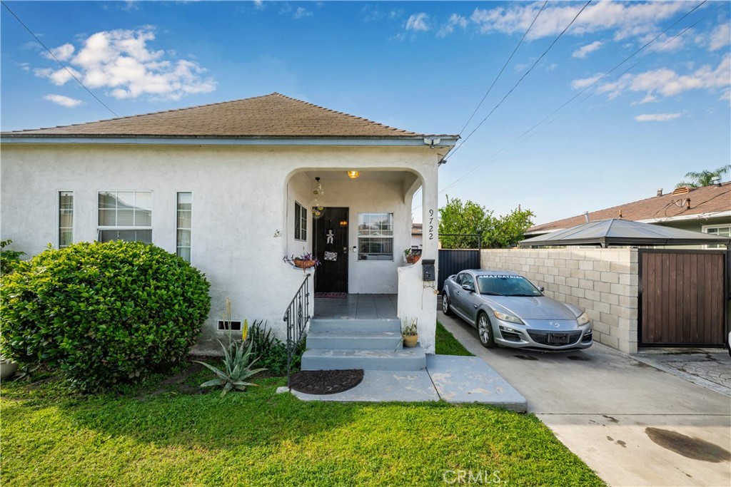 9722 Walnut Street Bellflower, CA 90706 - Photo 2 of 55 a front view of a house with garden