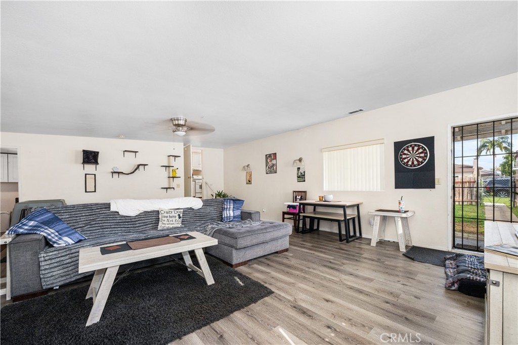 9722 Walnut Street Bellflower, CA 90706 - Photo 22 of 55 a living room with furniture a rug and white walls