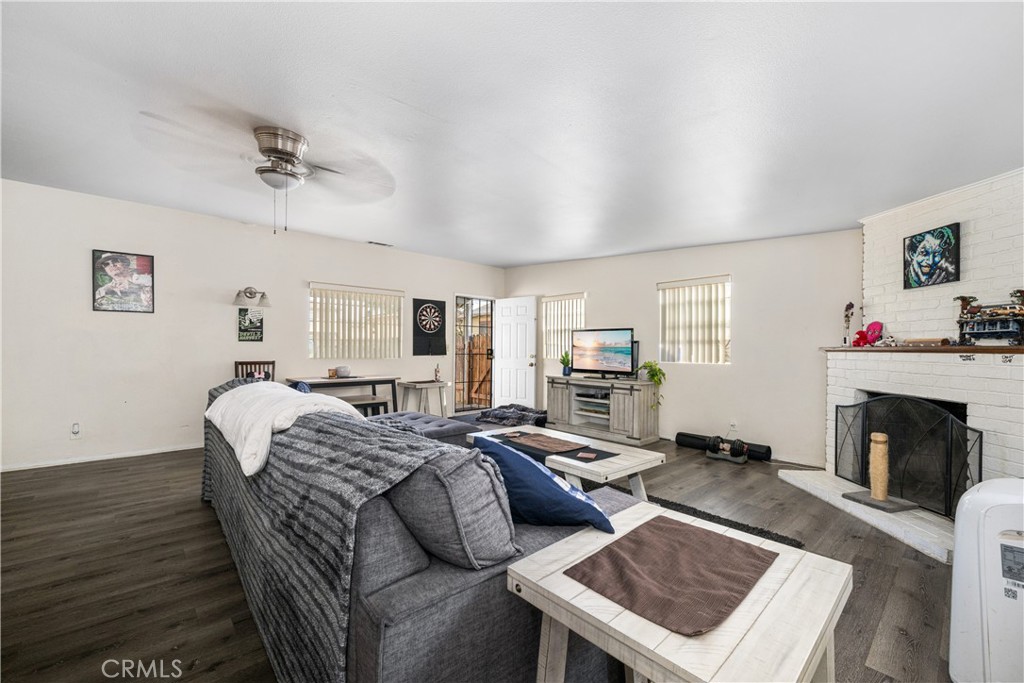 9722 Walnut Street Bellflower, CA 90706 - Photo 23 of 55 a living room with furniture a fireplace and a flat screen tv