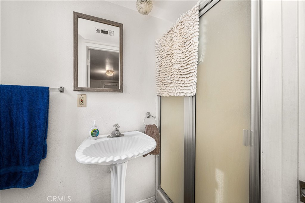 9722 Walnut Street Bellflower, CA 90706 - Photo 24 of 55 a bathroom with a granite countertop sink and a mirror