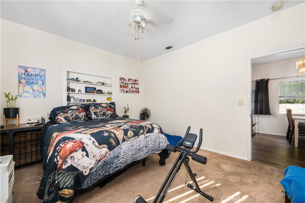 9722 Walnut Street Bellflower, CA 90706 - Photo 27 of 55 a bedroom with a bed and wooden floor