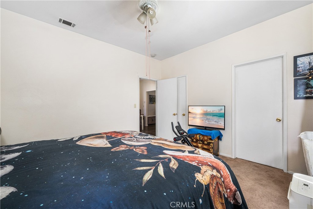 9722 Walnut Street Bellflower, CA 90706 - Photo 28 of 55 a bedroom with bed and a mirror