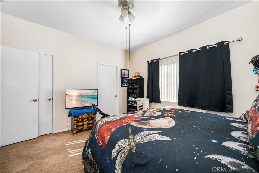 9722 Walnut Street Bellflower, CA 90706 - Photo 29 of 55 a bedroom that has a bed a dresser and mirror