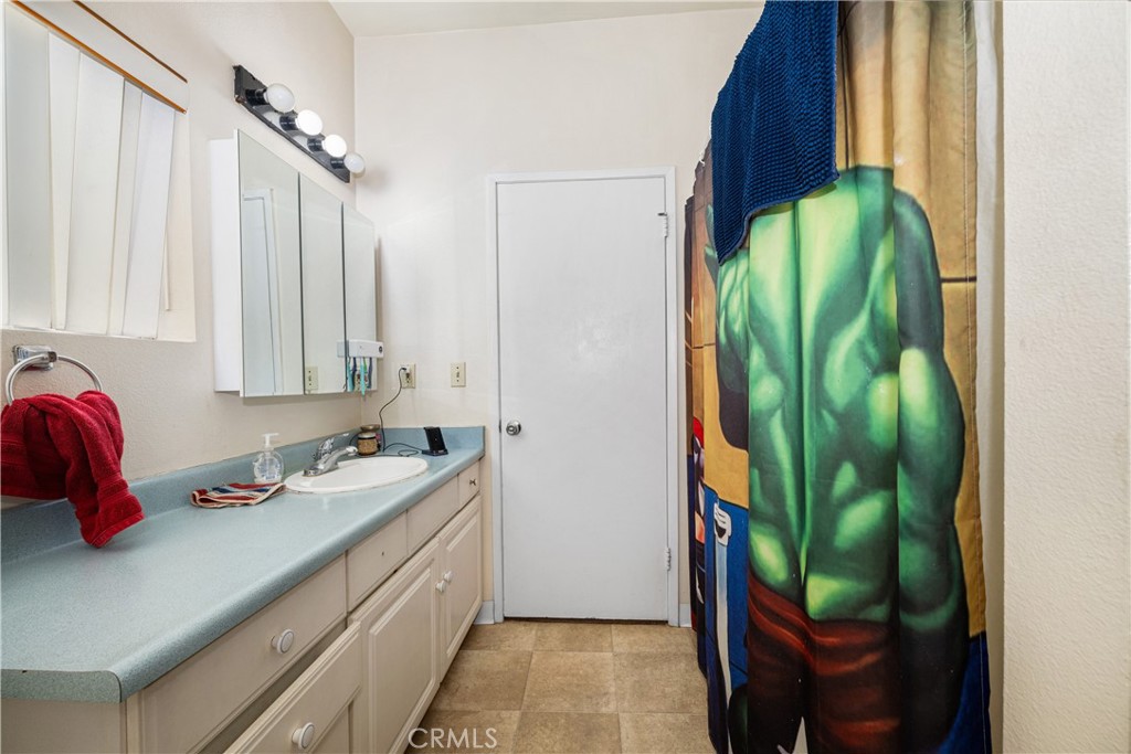 9722 Walnut Street Bellflower, CA 90706 - Photo 30 of 55 a bathroom with a sink and a mirror