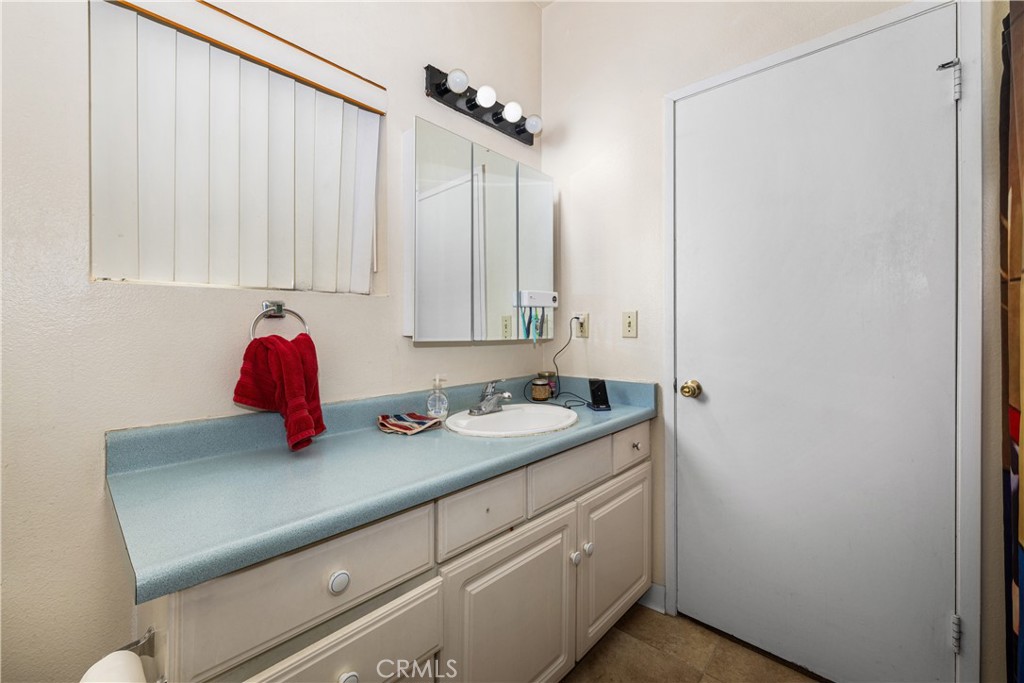 9722 Walnut Street Bellflower, CA 90706 - Photo 31 of 55 a bathroom with a sink and a mirror