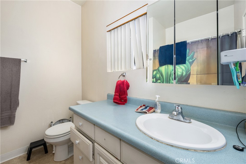 9722 Walnut Street Bellflower, CA 90706 - Photo 32 of 55 a bathroom with a sink toilet and mirror