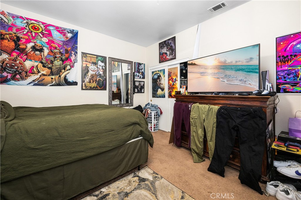 9722 Walnut Street Bellflower, CA 90706 - Photo 39 of 55 a living room with furniture and a flat screen tv